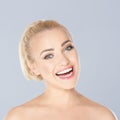 Happy blond woman with a beaming toothy smile Royalty Free Stock Photo