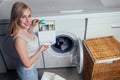 Happy blonde female washing clothes feeling happy about soft fresh laundry aroma fabric softener aromatherapy