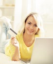 Happy blonde girl with credit card and notebook. Online shopping Royalty Free Stock Photo