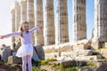 A tourist girl in front of an ancient, Greek temple in Athens Royalty Free Stock Photo