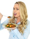 Happy Blonde Haired Cute Young Woman Eating a Roast Vegetable Salad Royalty Free Stock Photo