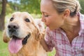 Happy blonde with her dog in the park Royalty Free Stock Photo