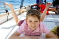 Happy blonde kid boy enjoying sailing boat trip. Family vacations on ocean or sea on sunny day. Healthy beautiful school Royalty Free Stock Photo