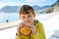 Happy blonde kid boy enjoying sailing boat trip. Family vacations on ocean or sea on sunny day. Healthy beautiful school Royalty Free Stock Photo