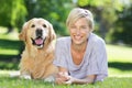 Happy blonde lying with her dog in the park Royalty Free Stock Photo