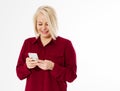 Happy blonde middle-aged woman in red suit isolated holding phone copy space