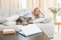 Happy blonde with pet cat on sofa Royalty Free Stock Photo