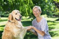 Happy blonde playing with her dog in the park Royalty Free Stock Photo