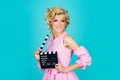 Happy blonde retro women actor holding clapboard making video cinema in studio. Movie production clapperboard, film Royalty Free Stock Photo