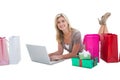 Happy blonde shopping online with laptop