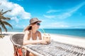 Happy blonde woman in hat and sunglasses on the tropical beach s Royalty Free Stock Photo