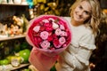 Happy blonde woman holding beautiful bright pink bouquet of peony roses in her hands Royalty Free Stock Photo