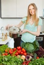 Happy blonde woman with pan and vegetables Royalty Free Stock Photo