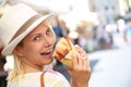 Happy blonde woman tasting Focaccia sandwich Royalty Free Stock Photo