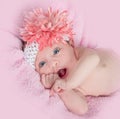 Happy blue eyed baby girl with a headband and flower Royalty Free Stock Photo