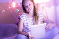 Happy blue-eyed girl holding her tablet Royalty Free Stock Photo