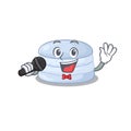 Happy blueberry macaron singing on a microphone