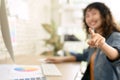 Happy blurred young woman graphic designer pointing finger at camera. Select focus to finger Royalty Free Stock Photo