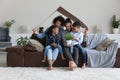 Happy bonding African American family celebrating moving into new home. Royalty Free Stock Photo