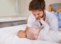 Happy, bonding and baby with father on bed relaxing, playing and resting together at home. Smile, love and young dad Royalty Free Stock Photo