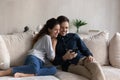 Happy bonding millennial hispanic family couple using mobile applications. Royalty Free Stock Photo