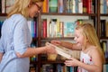 Happy, books and mother with child in library with smile, learning and reading with knowledge studying. Storytelling Royalty Free Stock Photo