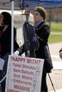 Woman holding cardboard Obama and banner