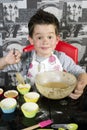 Happy boy baking muffins