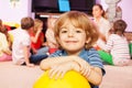 Happy boy with ball smiling and friends behind Royalty Free Stock Photo