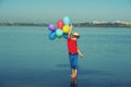 Happy boy with balloons on nature. Royalty Free Stock Photo