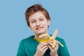 Happy boy with a banana in his handin green t-shirt Royalty Free Stock Photo