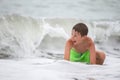 Happy boy bathes in the sea, plays Royalty Free Stock Photo