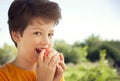 Happy boy biting the apple, A child with a fruit. Kid eating fresh pear Royalty Free Stock Photo