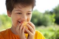 Happy boy biting the apple, A child with a fruit. Kid eating fresh pear Royalty Free Stock Photo