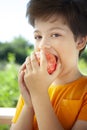 Happy boy biting the apple, A child with a fruit. Kid eating fresh pear Royalty Free Stock Photo