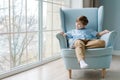 Happy boy in blue shirt relaxes with good thoughts. Peaceful guy is resting Royalty Free Stock Photo