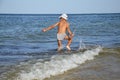 Happy boy bounce on the sea waves