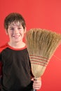 Happy boy with broom vertical Royalty Free Stock Photo