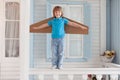 Happy boy with cardboard boxes of wings in home Royalty Free Stock Photo