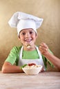 Happy boy with chef hat eating pasta Royalty Free Stock Photo