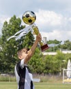 Happy boy child soccer player champion in football championship with trophy gold cup with golden football ball Royalty Free Stock Photo