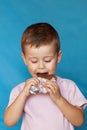 Happy boy with chocolate bar. Cute Little Boy Eating Chocolate Bar