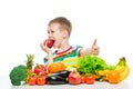 Happy boy on a diet with food, eating a red apple sitting Royalty Free Stock Photo