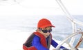 Happy boy driving a boat Royalty Free Stock Photo