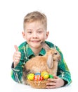 Happy boy with easter eggs embracing rabbit and showing thumbs up Royalty Free Stock Photo