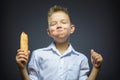 Happy Boy eating big sandwiche or hotdog isolated grey background Royalty Free Stock Photo