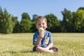 A happy boy is eating ice cream outdoors in the park Royalty Free Stock Photo
