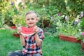 Happy boy eating watermelon in the garden. Kids eat fruit outdoors. Healthy snack for children Royalty Free Stock Photo