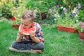 Happy boy eating watermelon in the garden. Kids eat fruit outdoors. Healthy snack for children Royalty Free Stock Photo