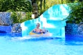 Happy boy enjoying waterslide Royalty Free Stock Photo